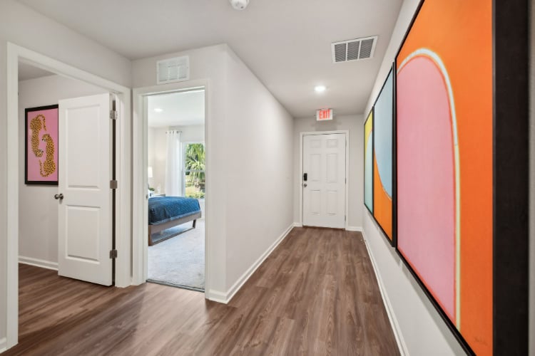 A room with a bed and a mirror.