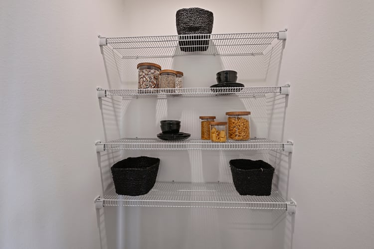 A white shelving unit with various objects on it.