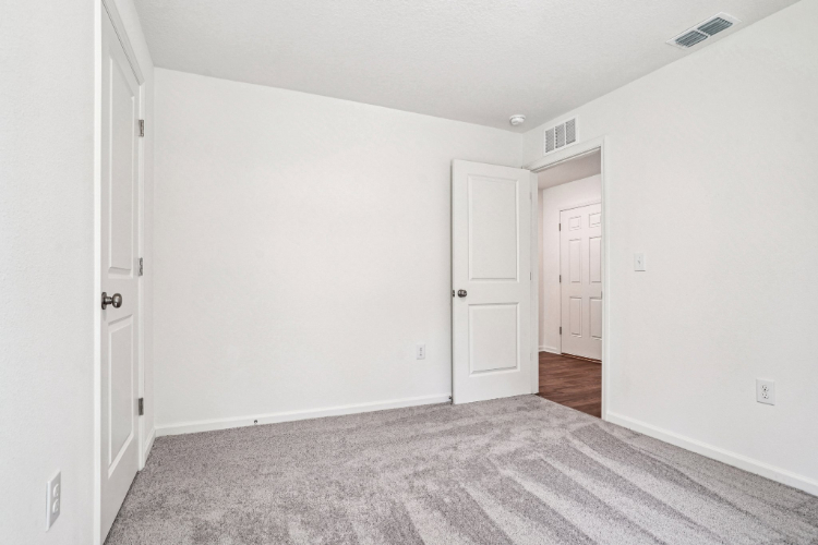 A hallway with white doors.