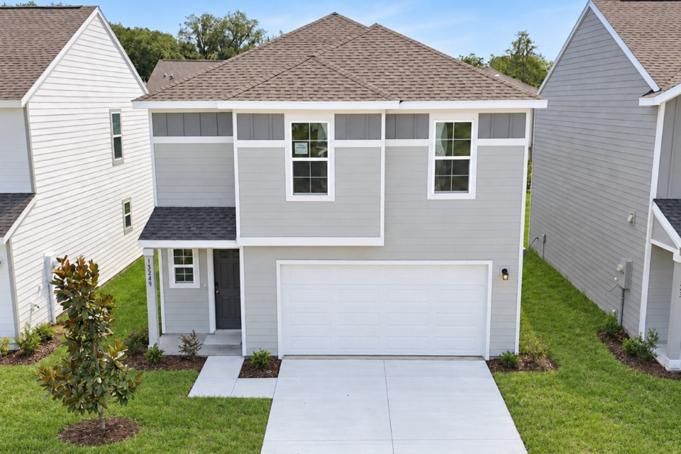 A white house with a garage.