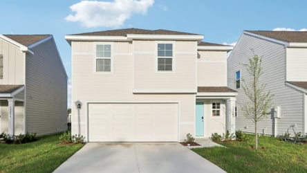 A white garage in a neighborhood.