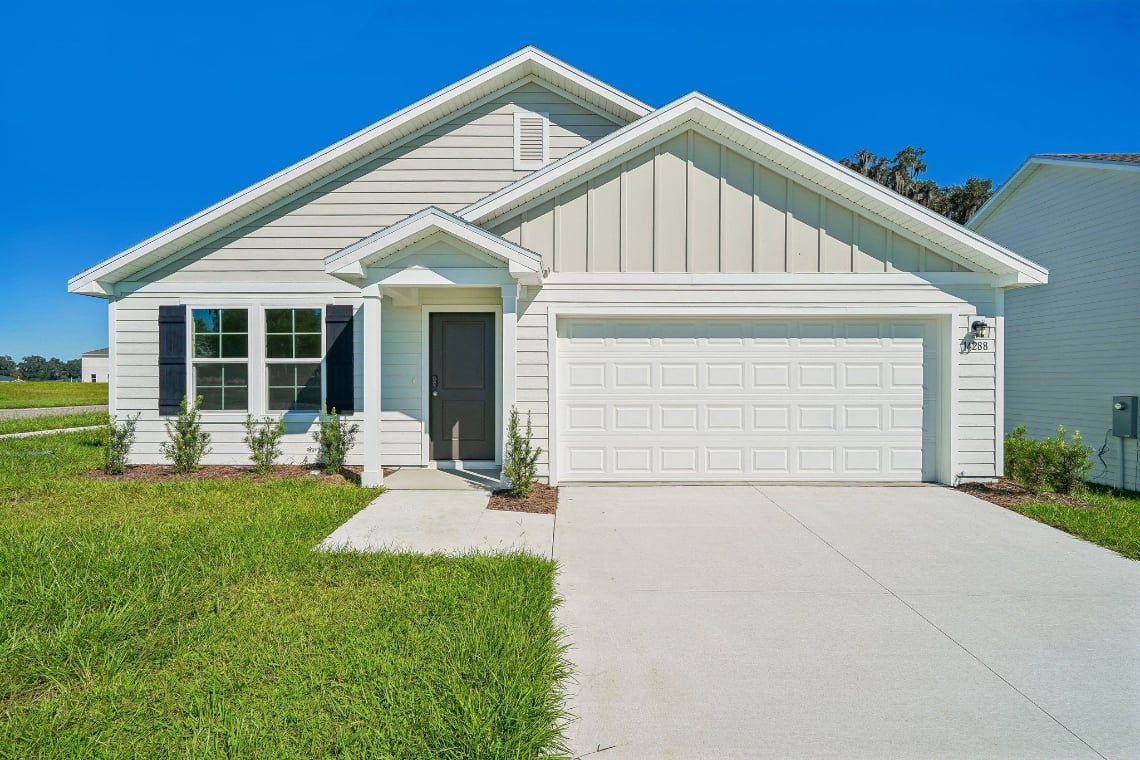 A white house with a garage.