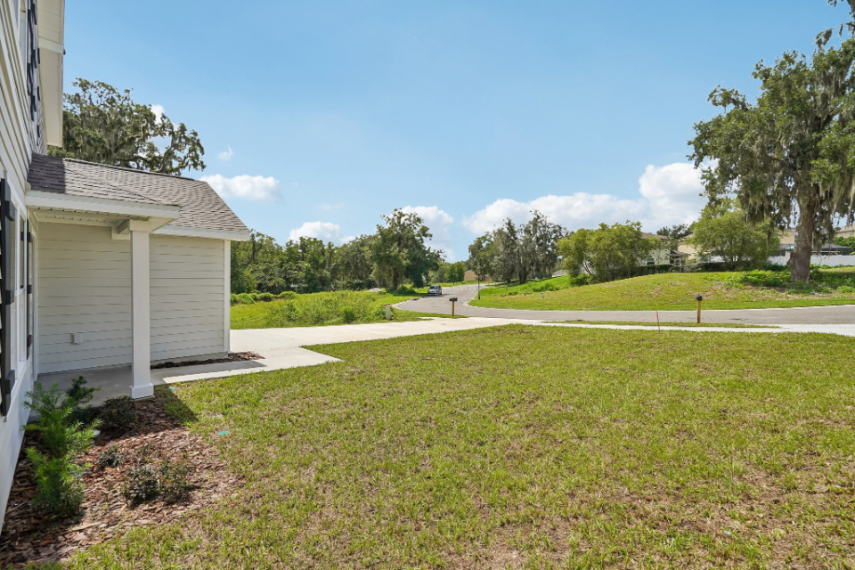 A house with a driveway and grass.