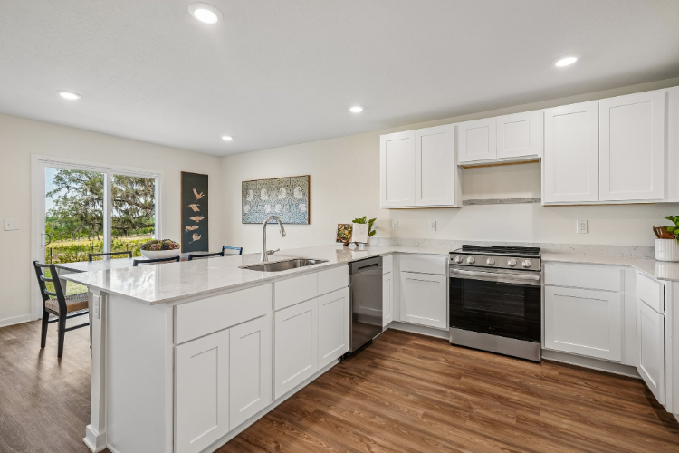A kitchen with white cabinets.