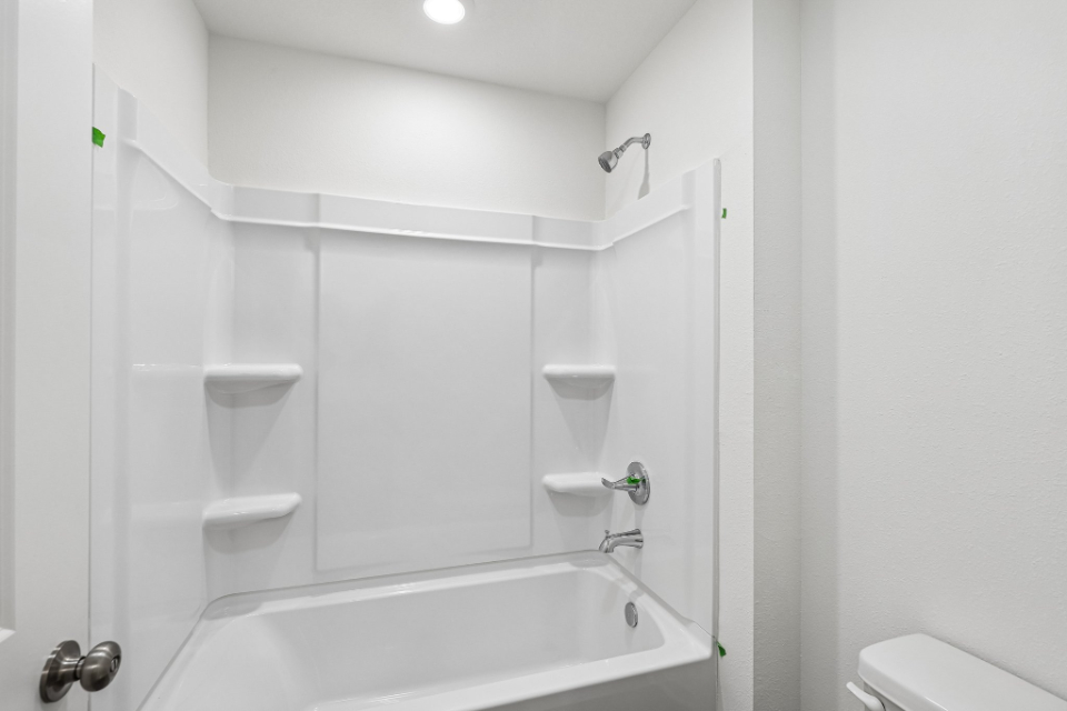A bathroom with a bathtub sink and toilet.