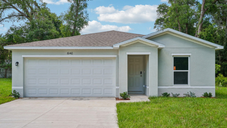 A white house with a garage.