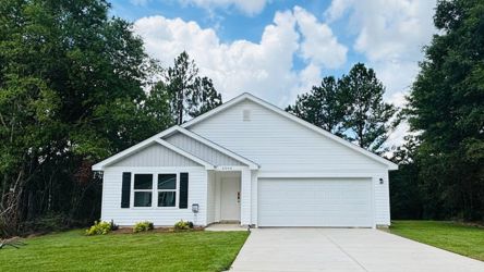 A white house with a driveway.