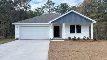 A white house with a garage.