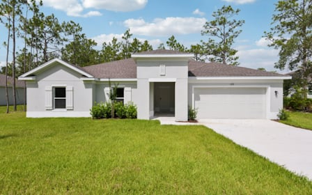 A white house with a driveway.
