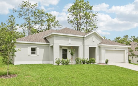A white house with a cross on the roof.