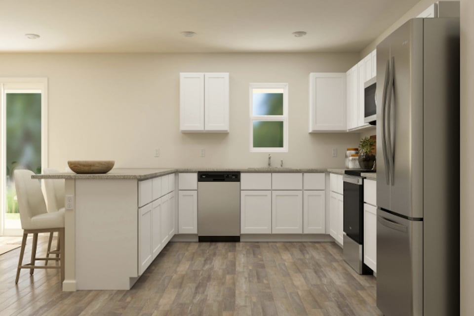 A kitchen with white cabinets.