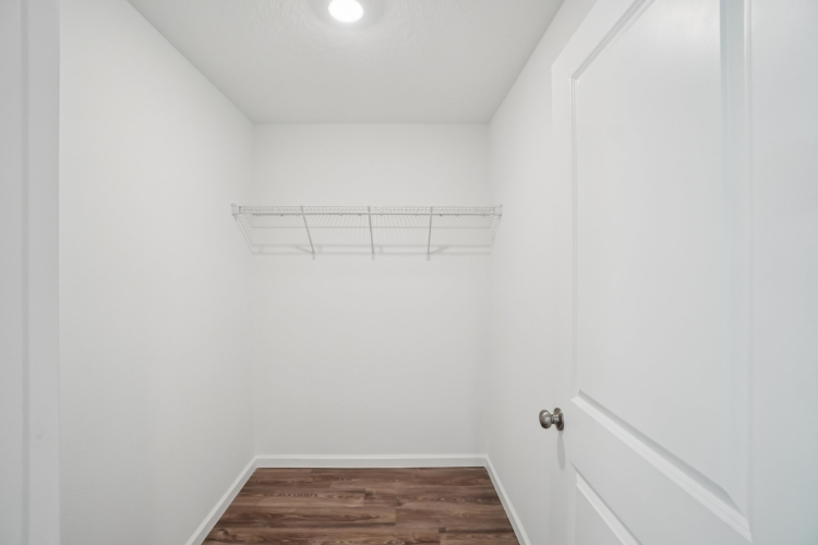 A room with white walls and a wood floor.