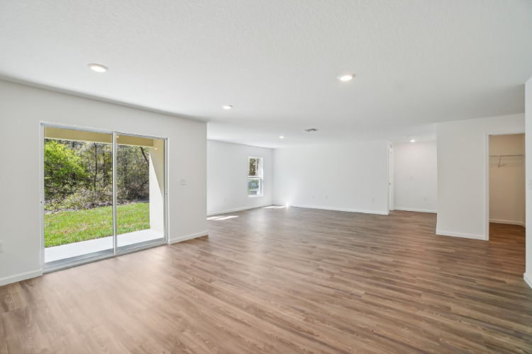 A room with a wood floor and a large glass door.