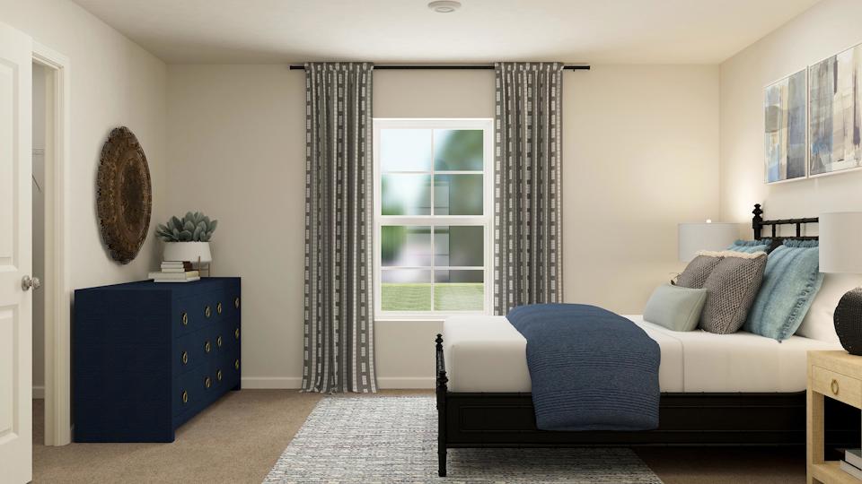 A bedroom with a bed and a window.