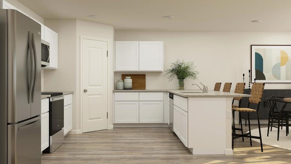 A kitchen with white cabinets.