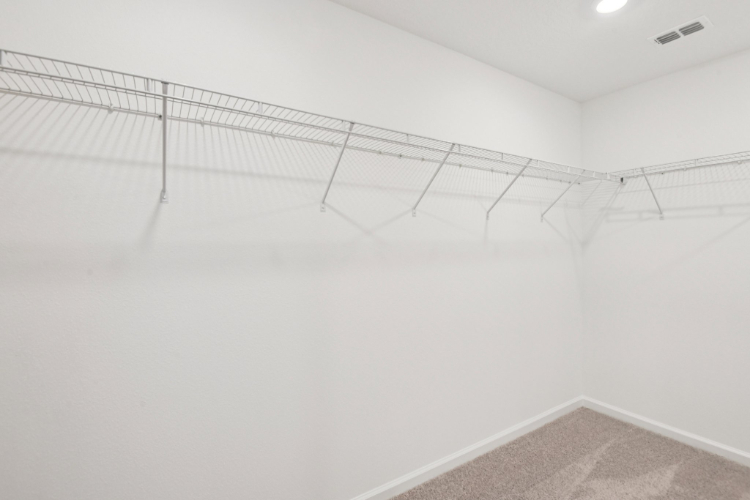 A white wall with a metal railing.