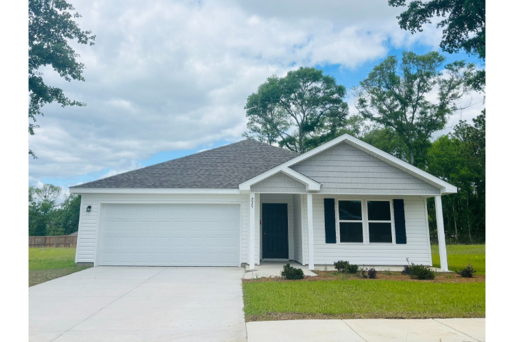 A white house with a garage.