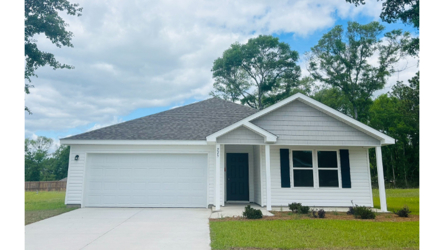 A white house with a garage.