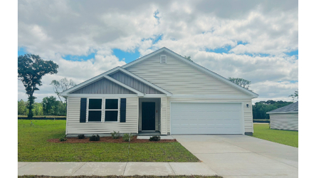 A white house with a garage.