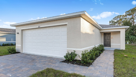 A white house with a driveway.