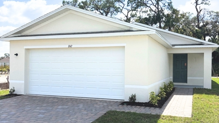 A white garage with a door.
