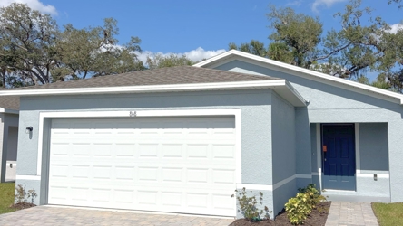 A white garage with a blue door.