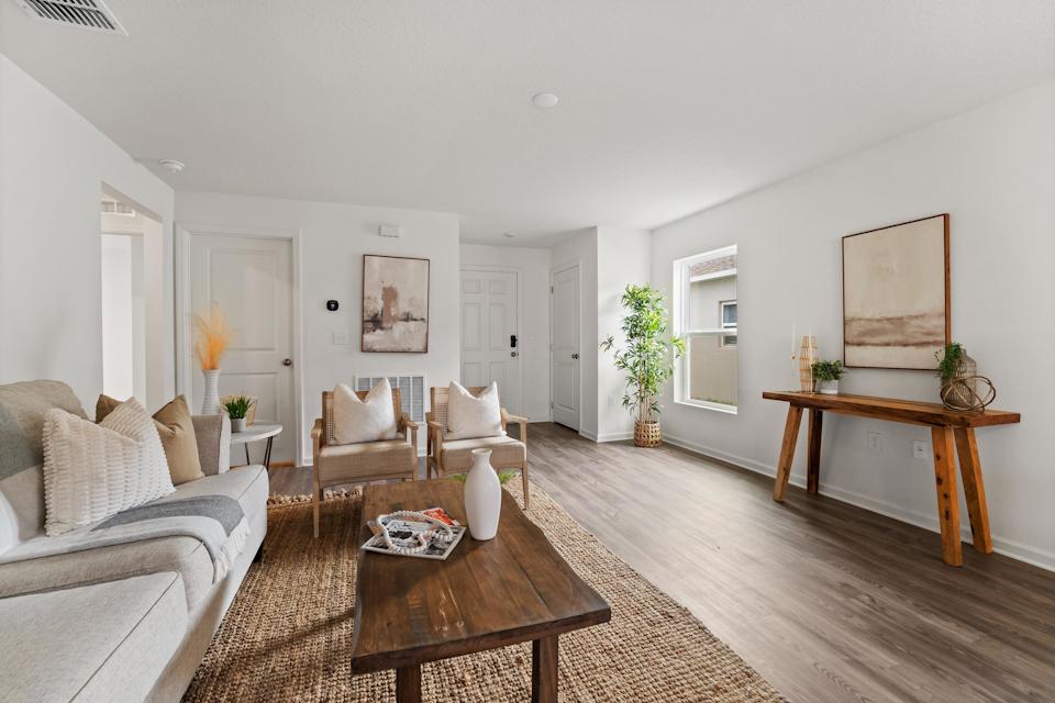 A living room with a wood floor.