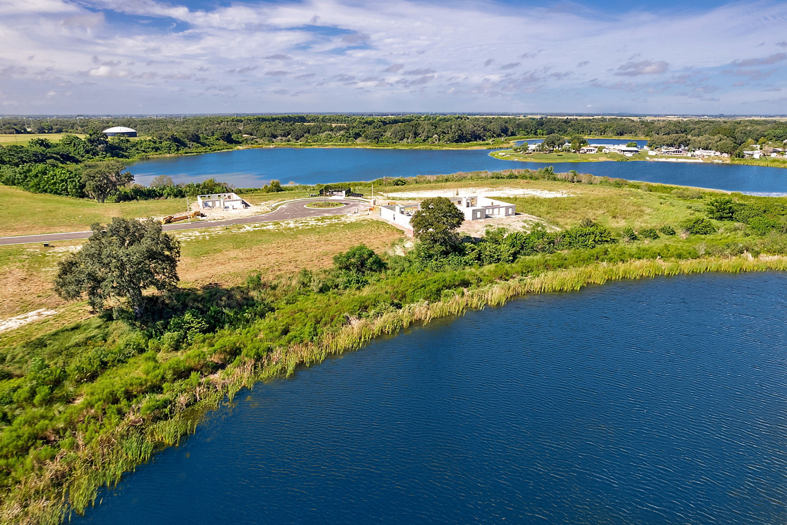 A body of water with buildings and trees around it.
