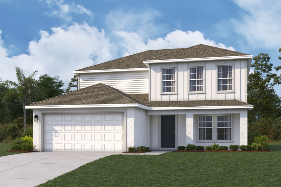 A white house with a garage.