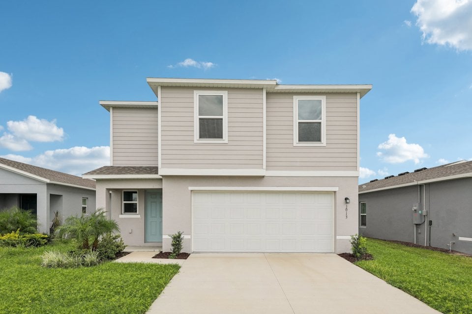 A white house with a garage.