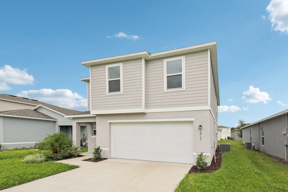A white house with a garage.