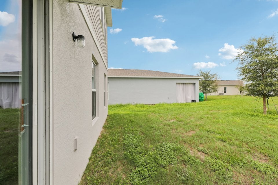 A grassy area with buildings in the background.