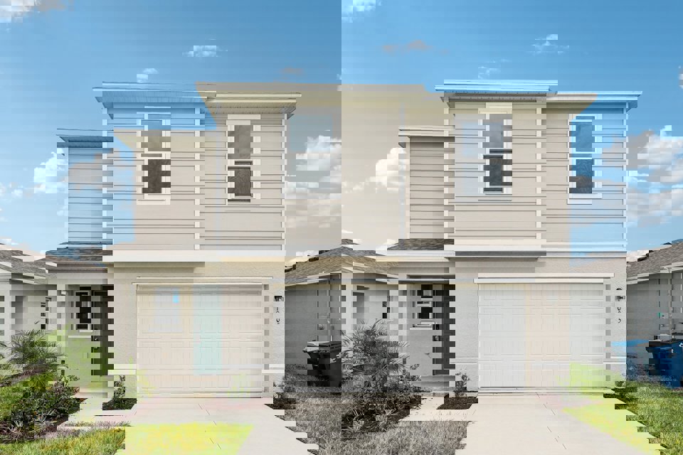 A white house with a garage.