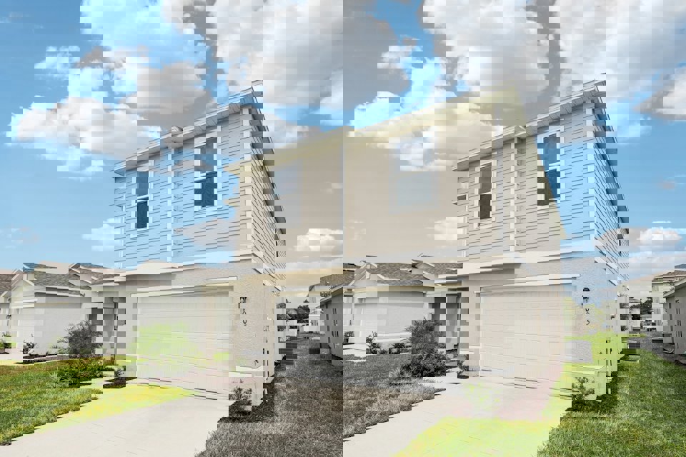 A white house with a garage.