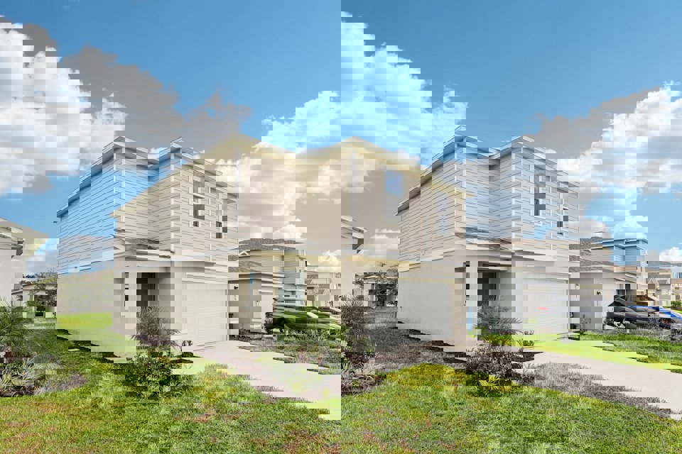 A white house with a garage.