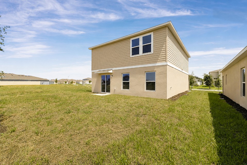 A house with a grass yard.