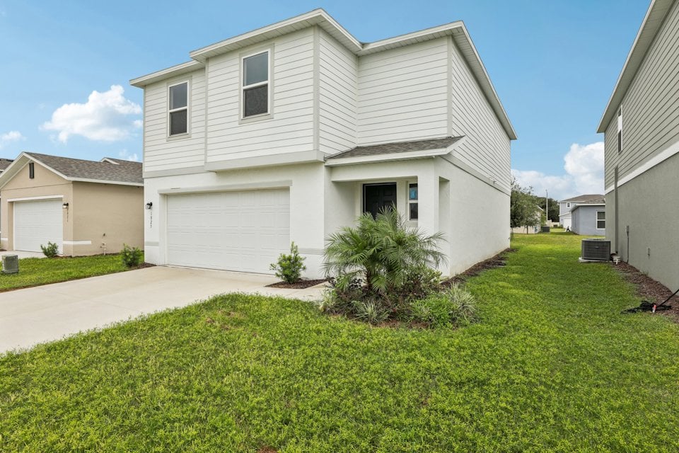A white house with a driveway.