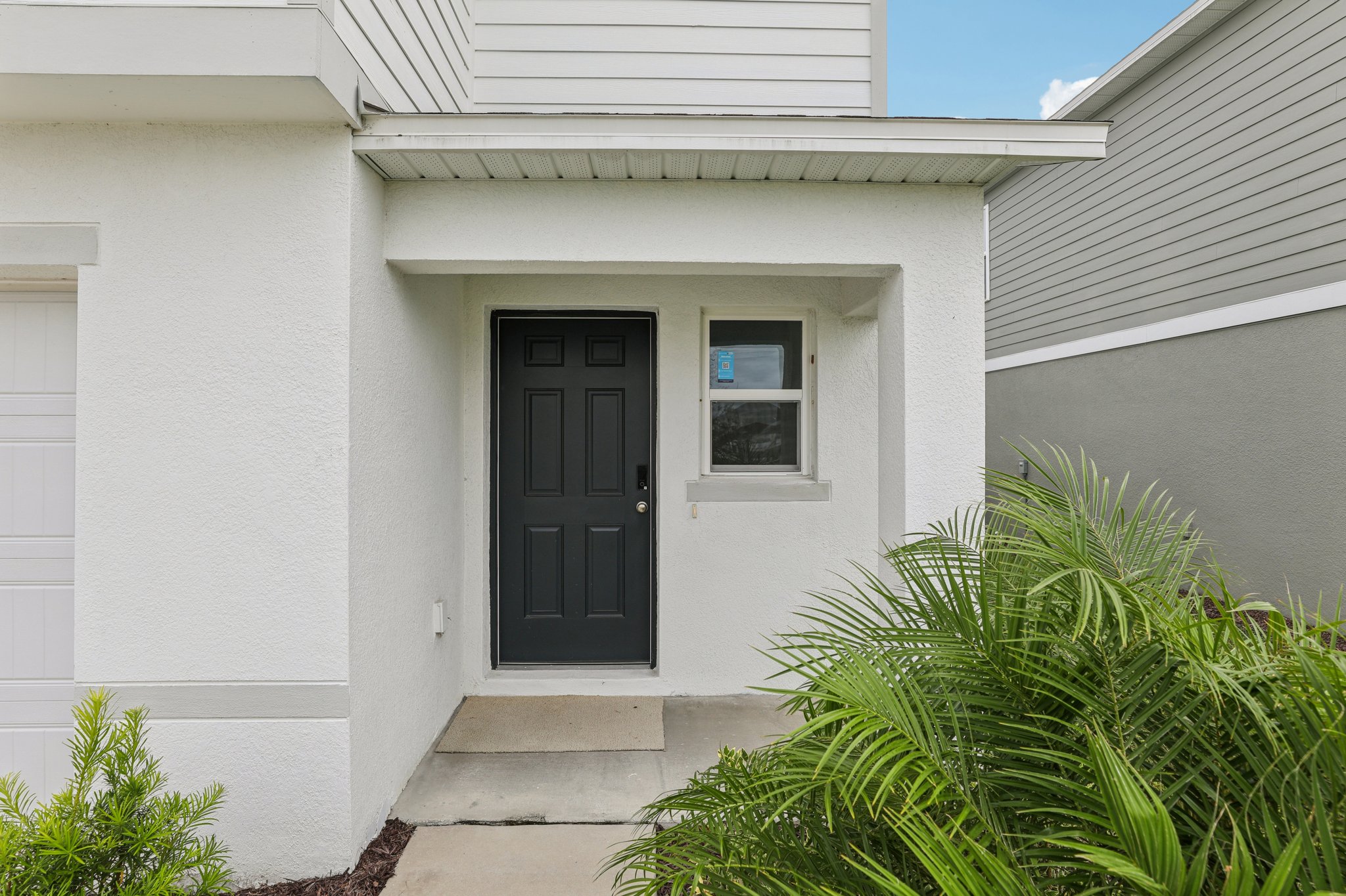 A white house with a black door.