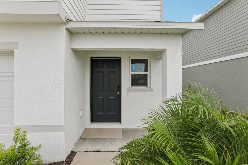 A white house with a black door.
