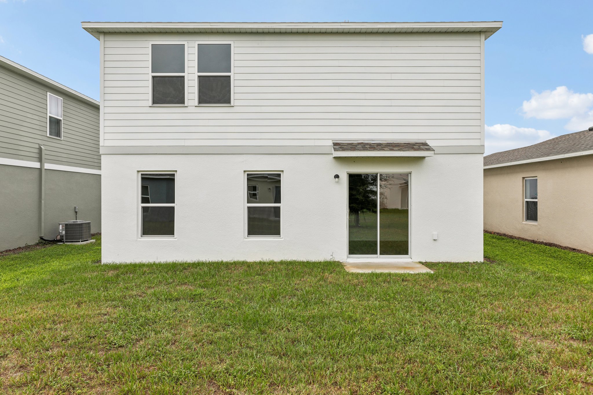 A white house with a garage.