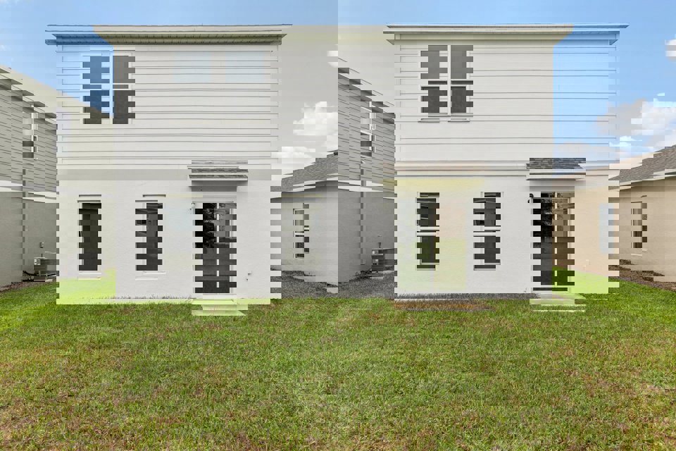 A white house with a garage.