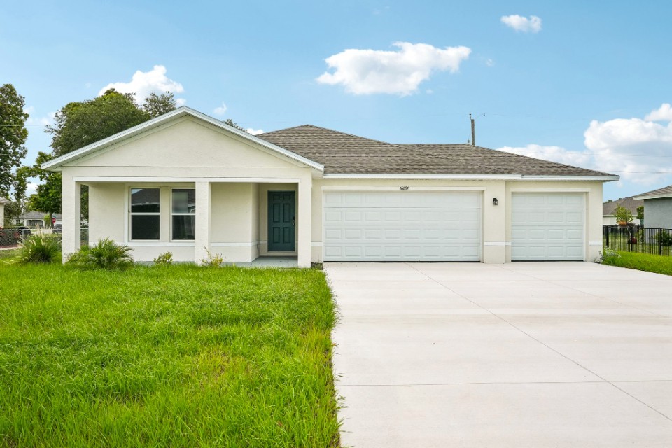 A white house with a garage.