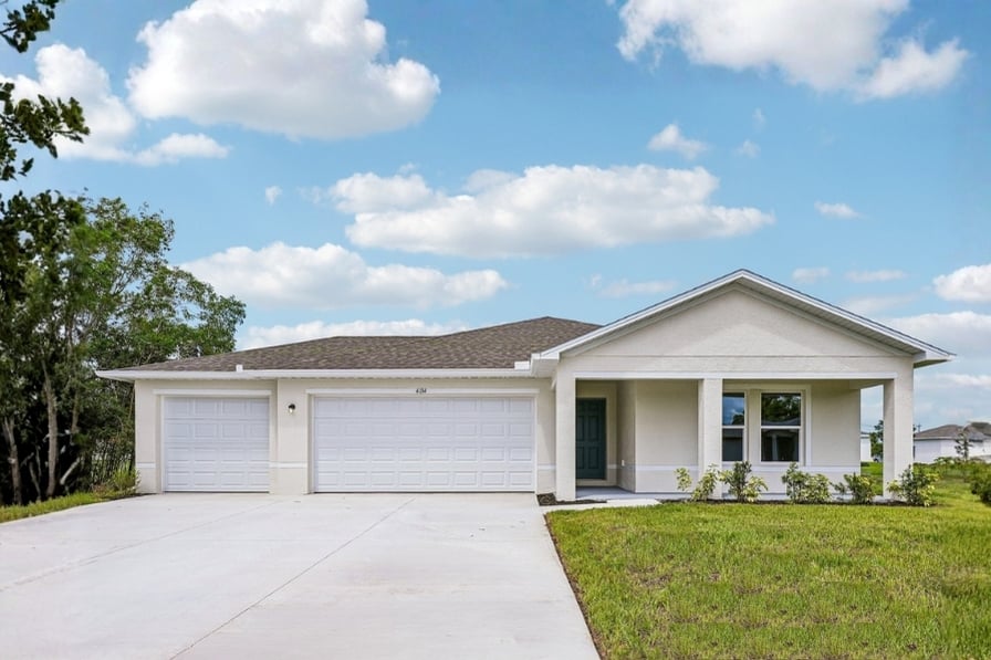 A house with garages and grass.