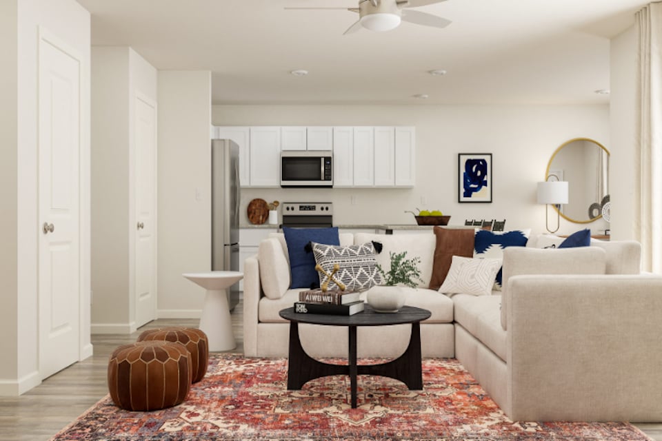 A living room with white furniture.