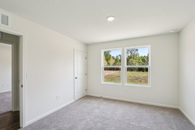 A room with a window and a door.