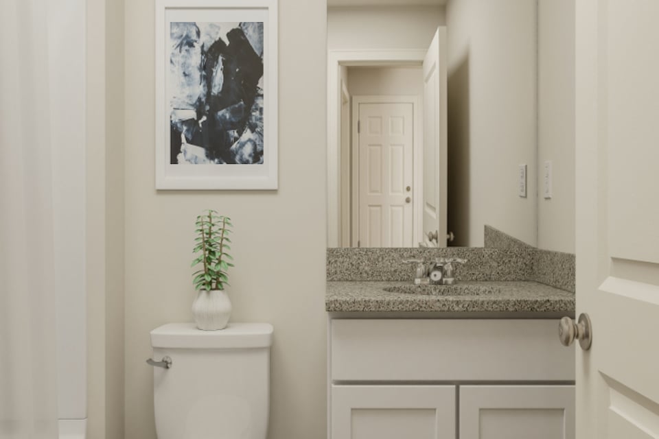 A bathroom with a marble countertop.