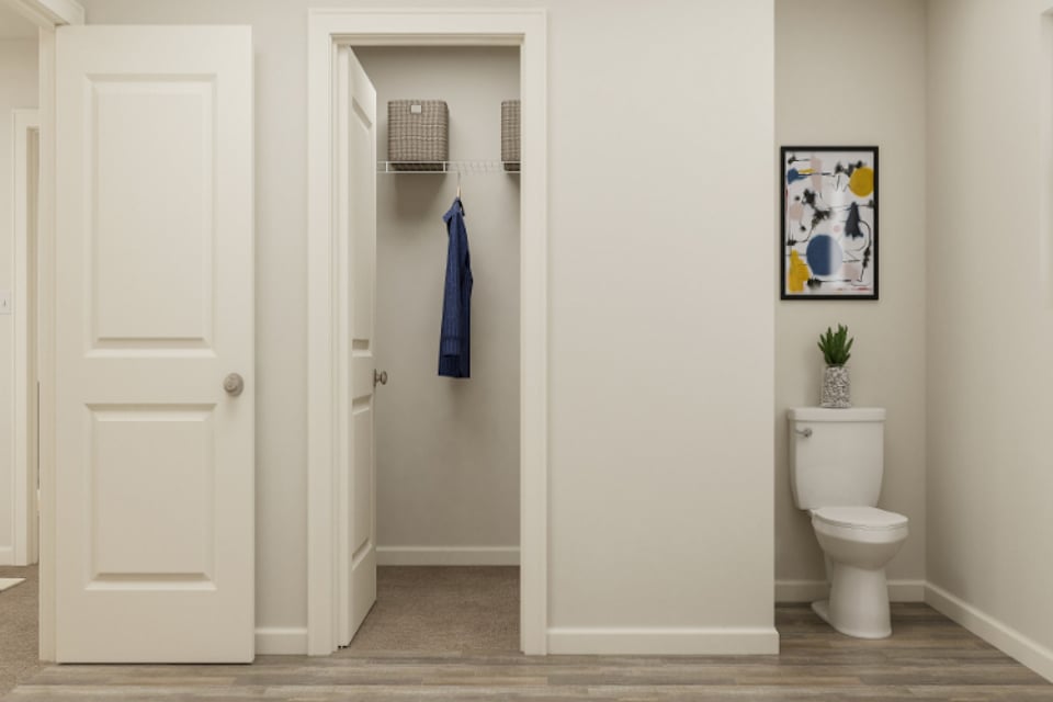 A bathroom with a toilet and a shower unit.