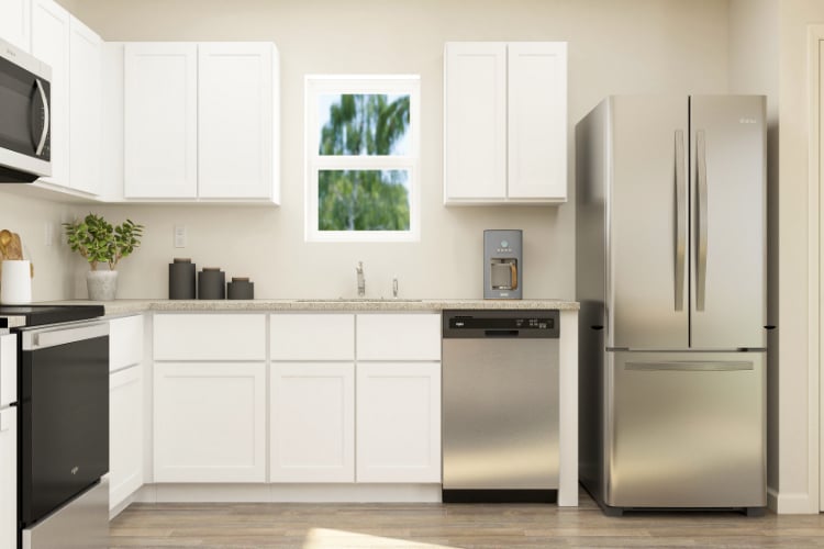 A kitchen with white cabinets.