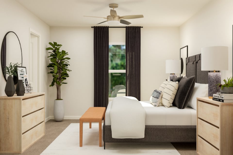 A living room with a white couch and a white chair.