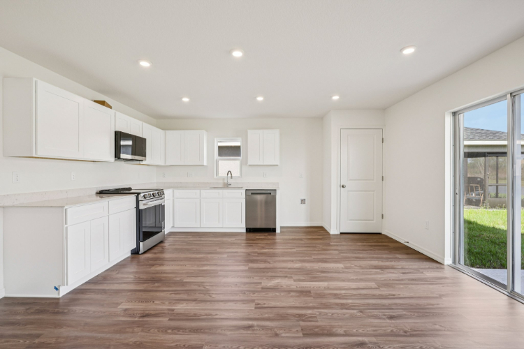 A kitchen with white cabinets.